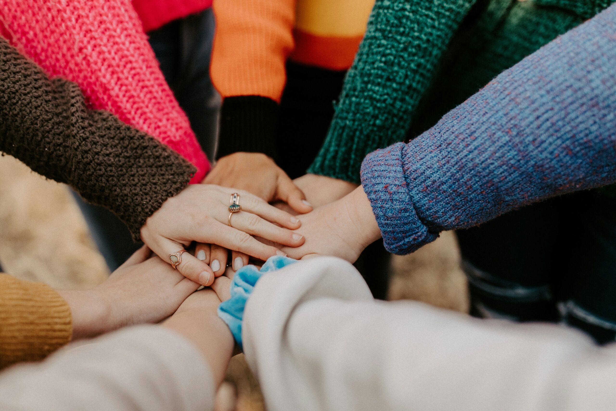 Girl friends hands piled together, teamwork.